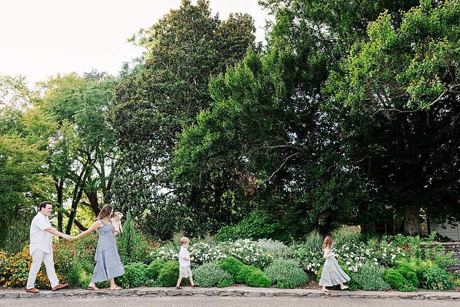family walking in garden during baby's first year session