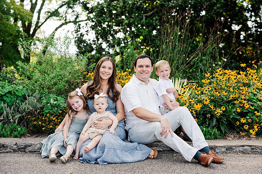 family sitting together at garden during baby's first year session