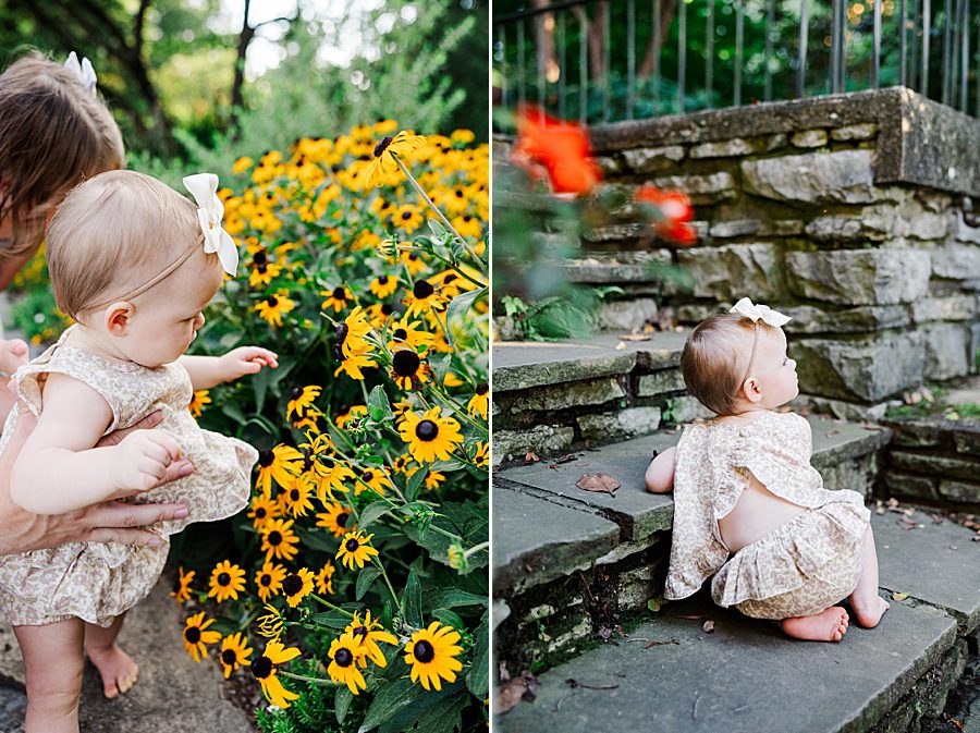 baby girl playing with yellow flowers