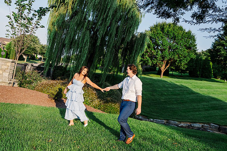 couple holding hands and walking at farragut engagement session