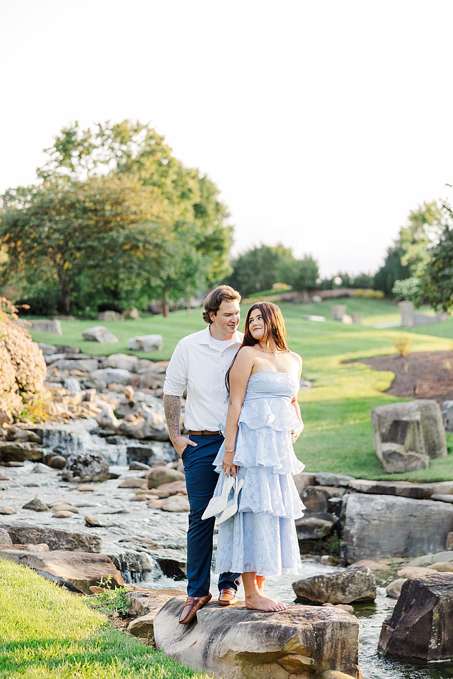 couple standing by ornate water feature