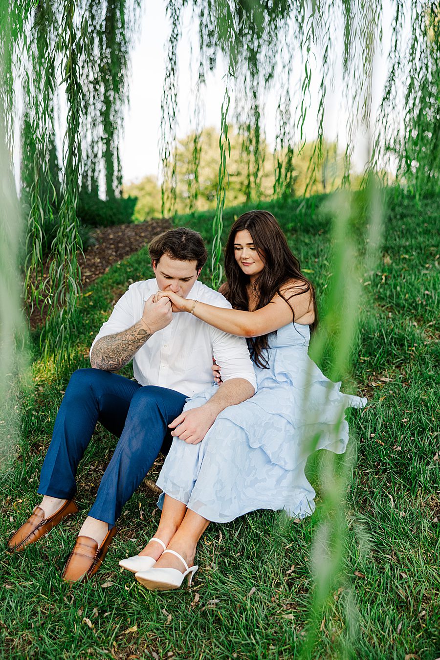 man kissing woman on hand