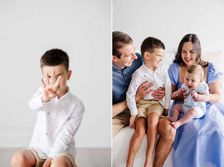 little boy holding up 4 fingers at white room family session