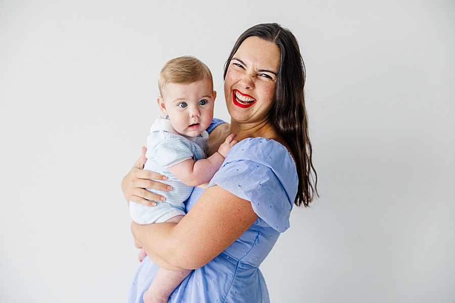 mom holding son at white room family session
