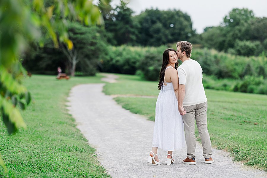 kiss on cheek at knoxville botanical summer engagement