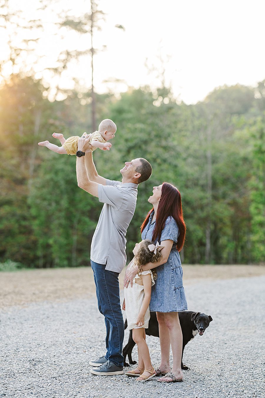 family playing together at golden hour