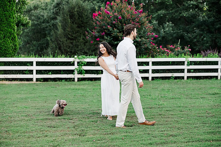 couple playing with dog at castleton estate engagement session