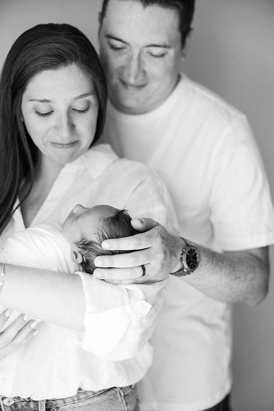 mom and dad holding new baby