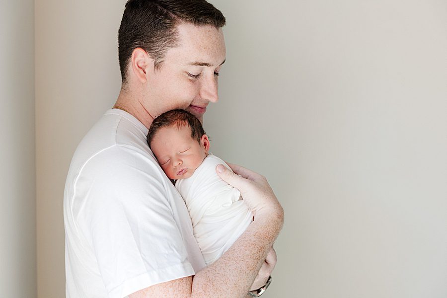 dad holding son against chest