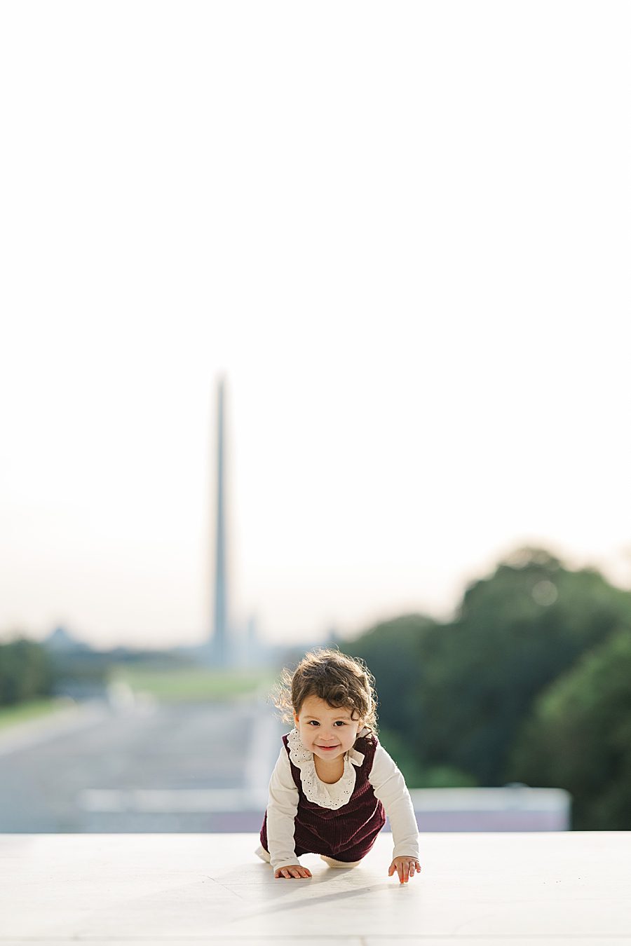 baby crawling in front of washington monument at lincoln memorial sunrise session