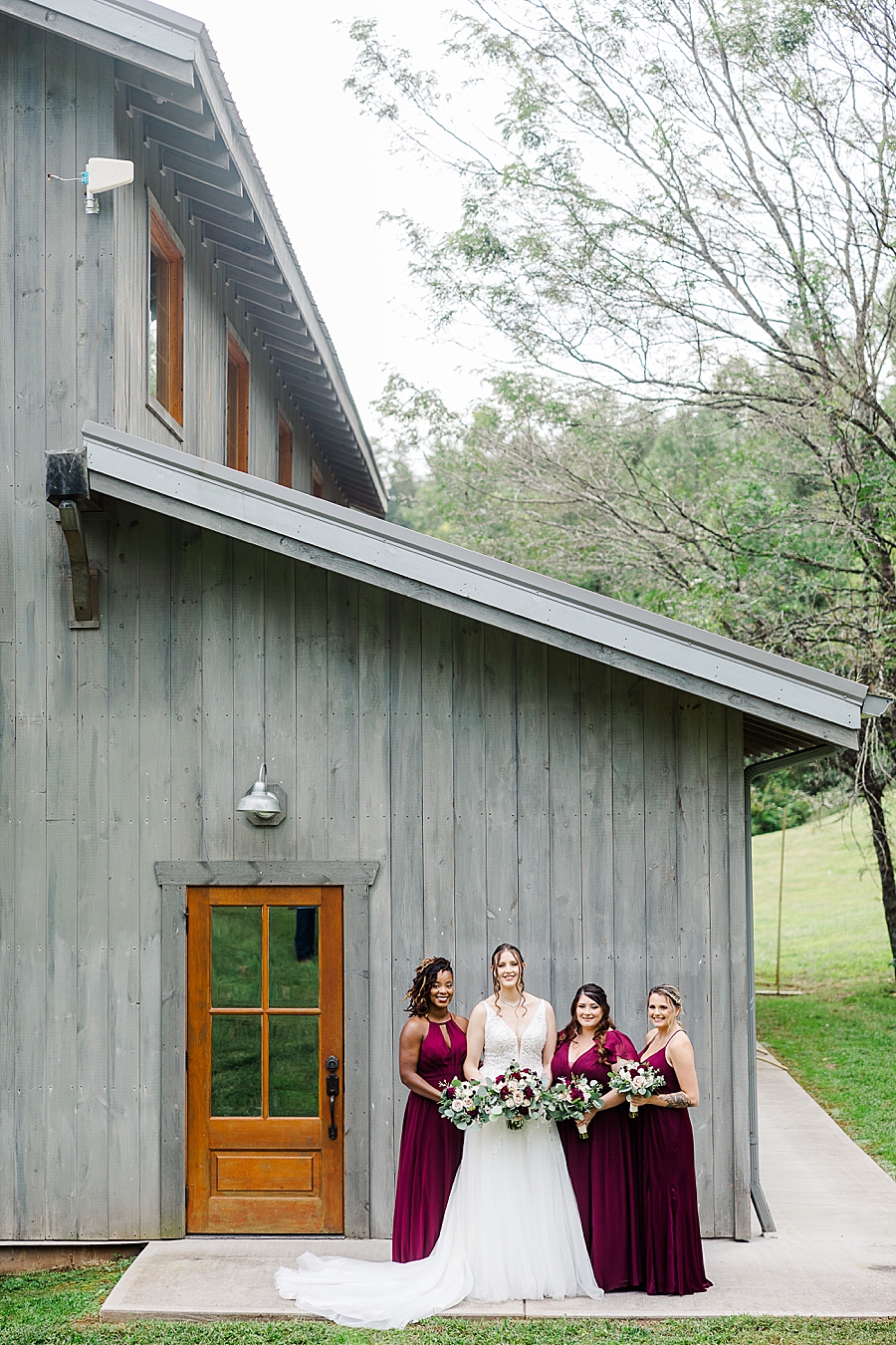 bridal party in from of barn