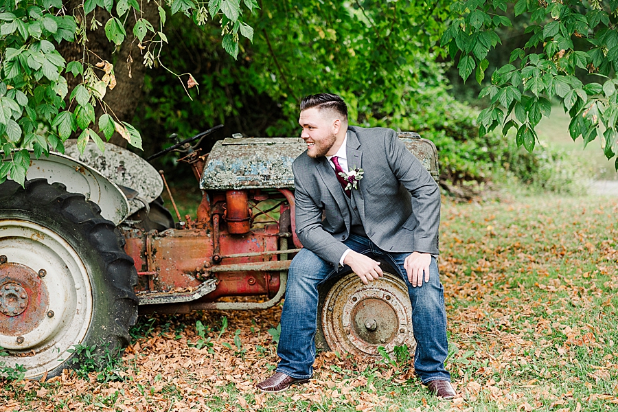 groom sitting on old tractor