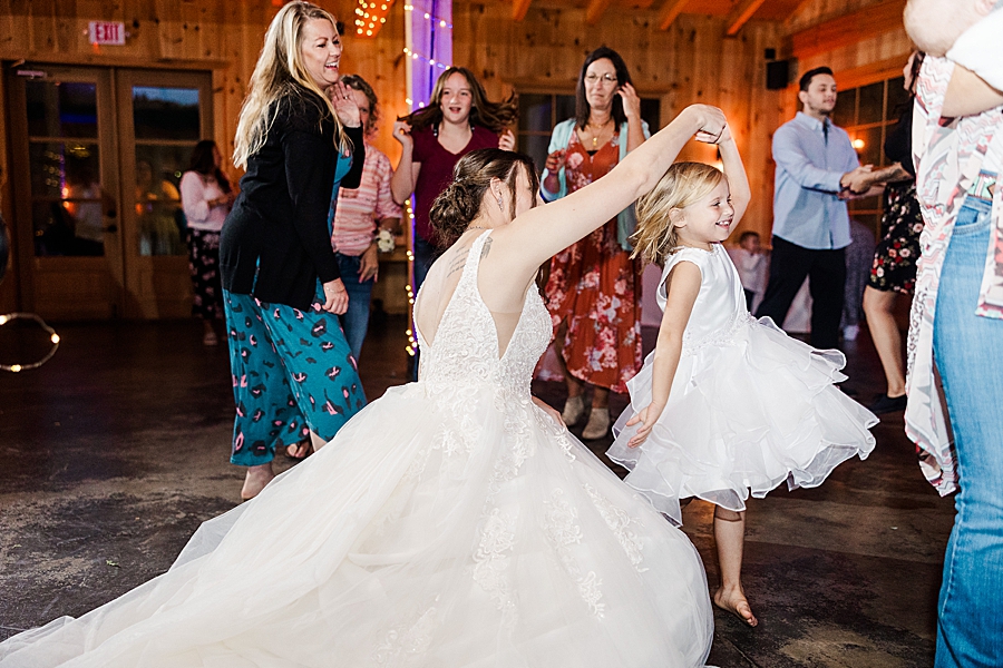 bride dancing with flower girl