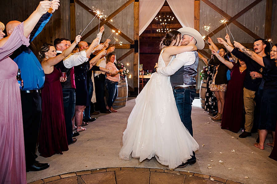 couple kissing during sparkler exit