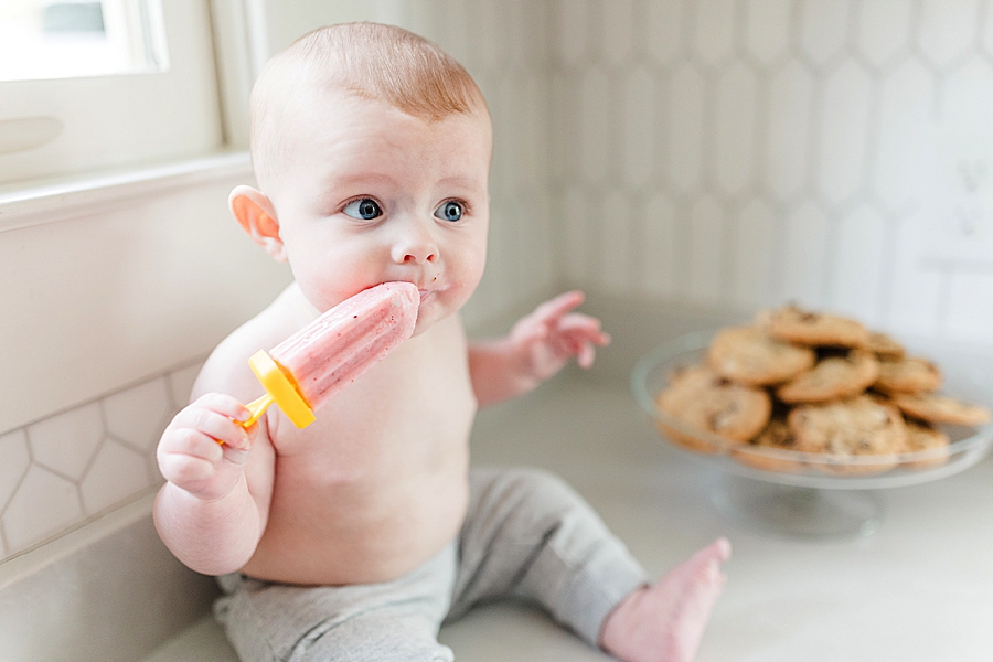 baby eating popsicle at 6 month session