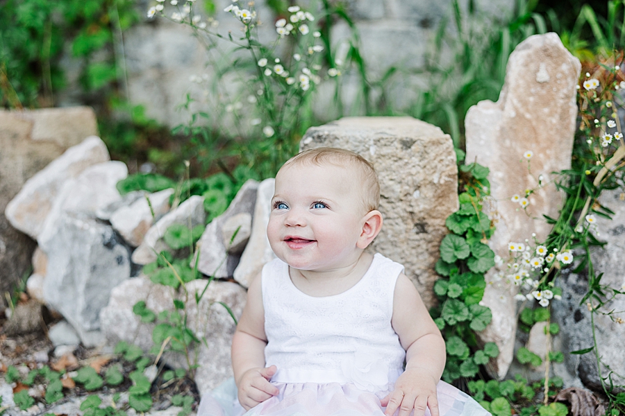 little girl sitting on rocks