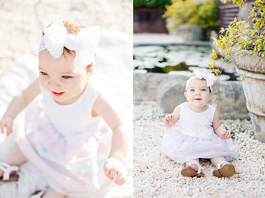 baby in white bow at 9 month session