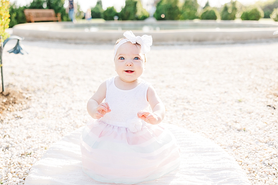 baby on white gravel at 9 month session