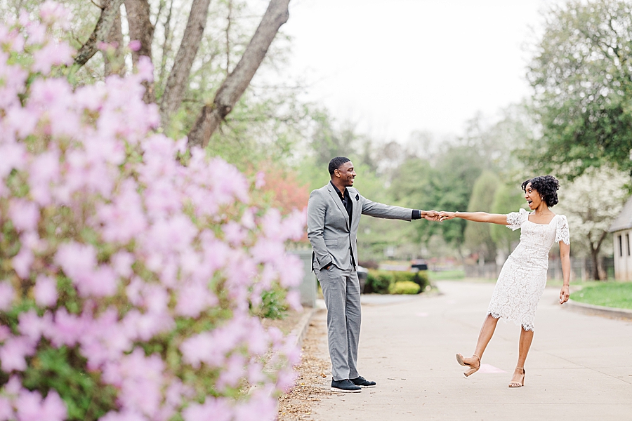 Dancing in front of flowers at this Sequoyah Hills Proposal by Amanda May Photos.