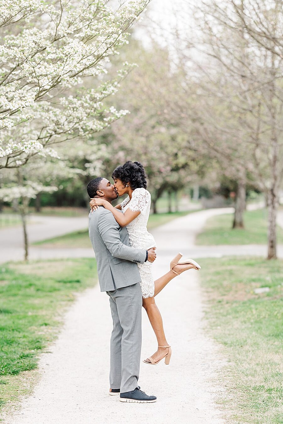 Kissing during a lift on the path at this Sequoyah Hills Proposal by Amanda May Photos.