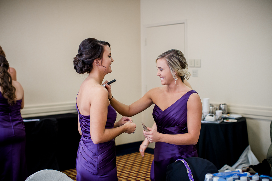 Historic Westwood in Knoxville, TN bridesmaids helping each other.