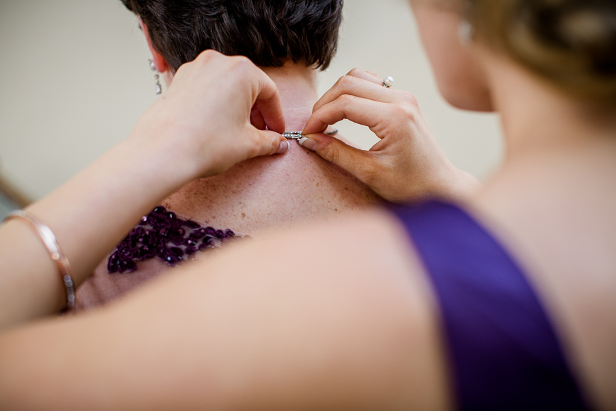 Historic Westwood in Knoxville, TN clasping mother of bride's necklace.