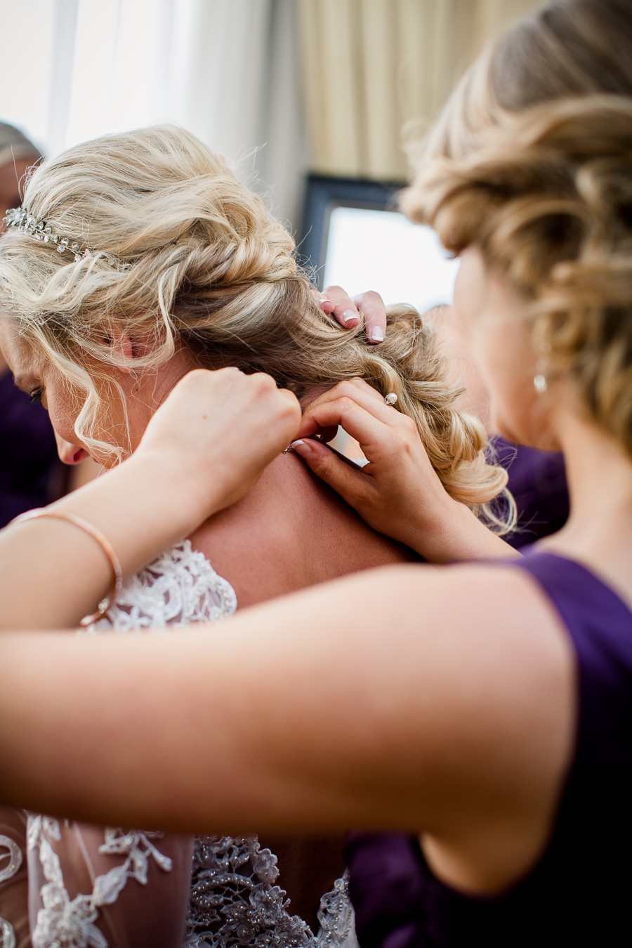 Historic Westwood in Knoxville, TN maid of honor putting on bride's necklace.