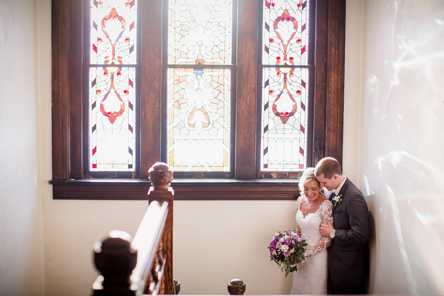 Historic Westwood in Knoxville, TN cuddling in front of stain glass window.