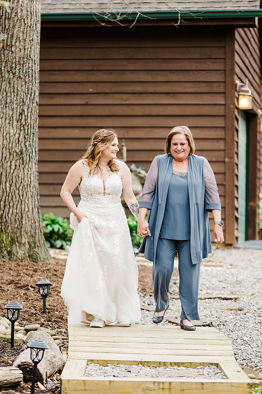 mother walking daughter down aisle
