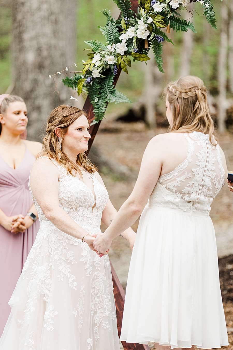 brides holding hands at backyard wedding