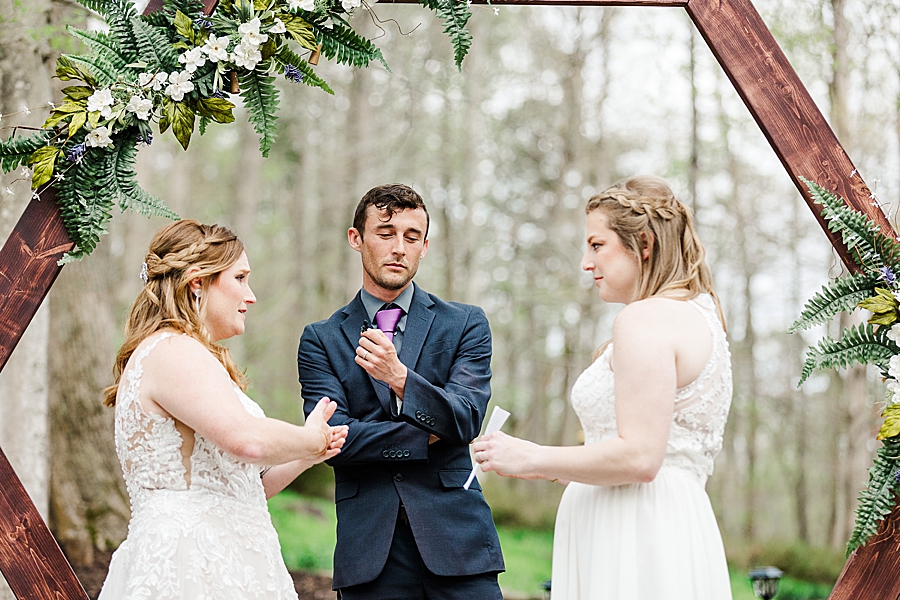 signing vows at backyard wedding