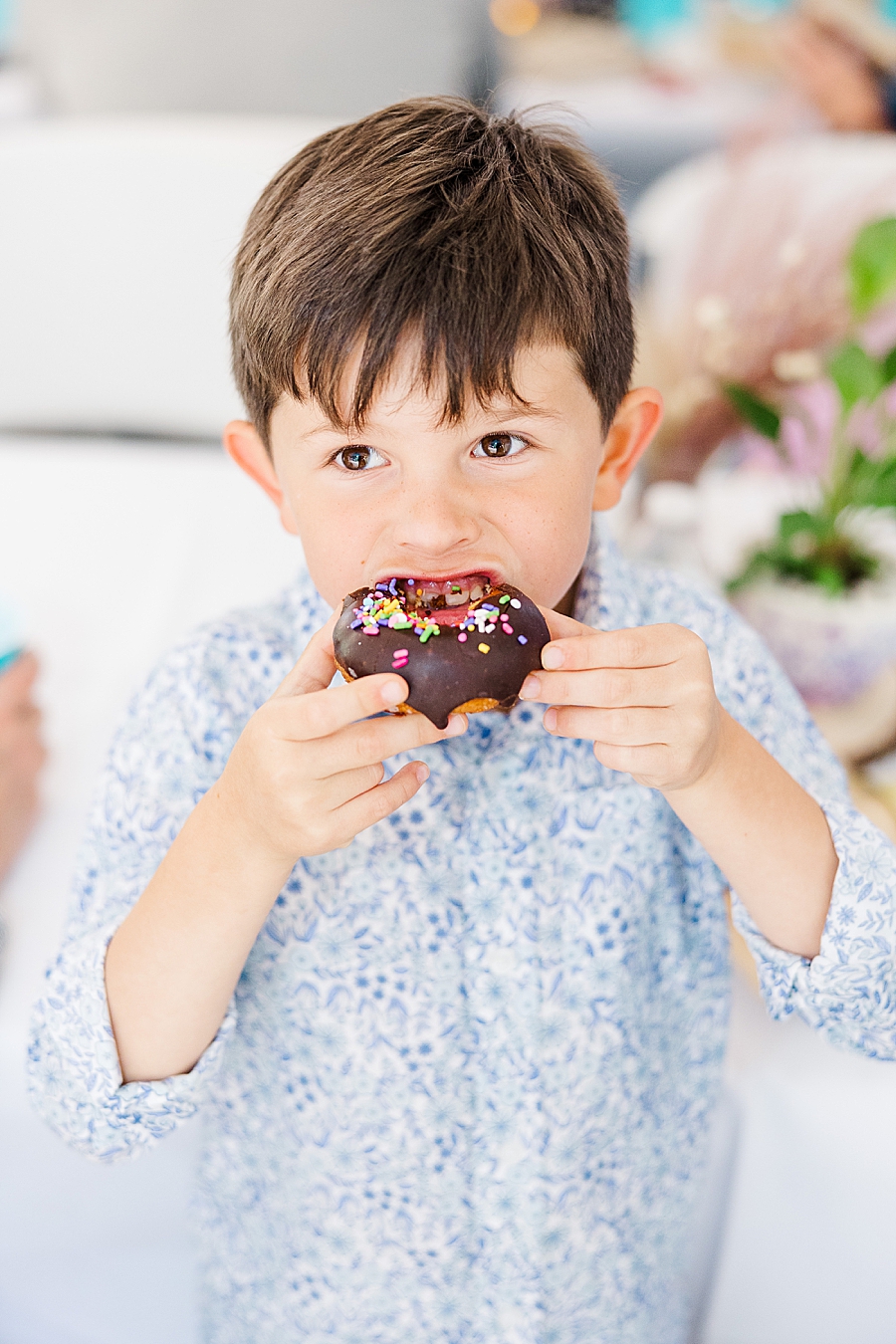 boy eating chocolate donut
