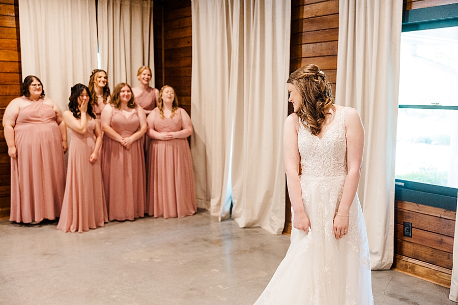 Bridesmaids react to back of wedding dress at Julianna Wedding by Amanda May Photos