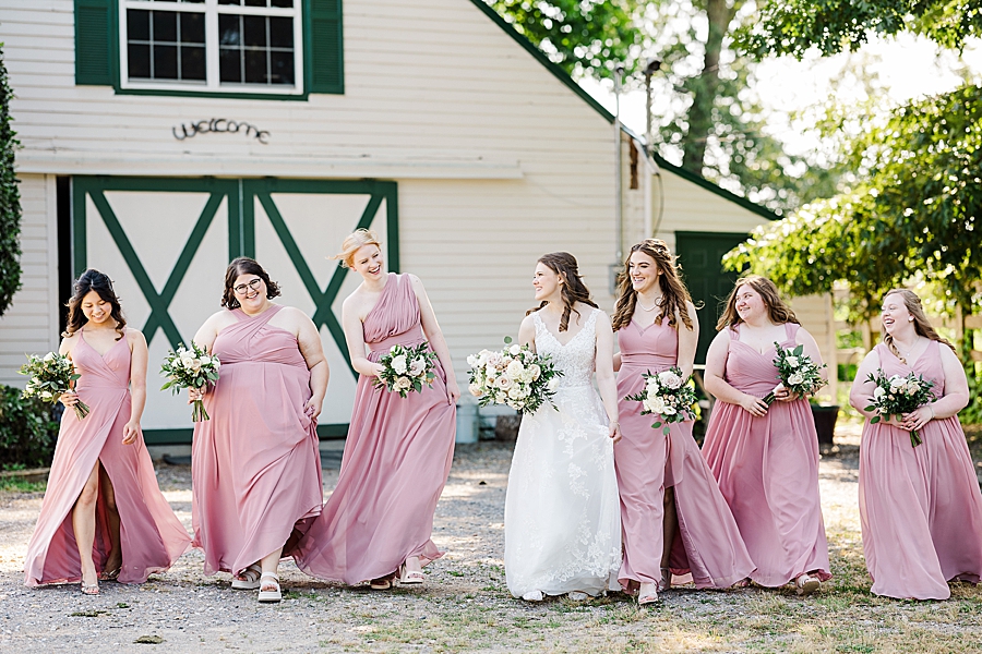Bride walking with bridesmaids at wedding by Amanda May Photos