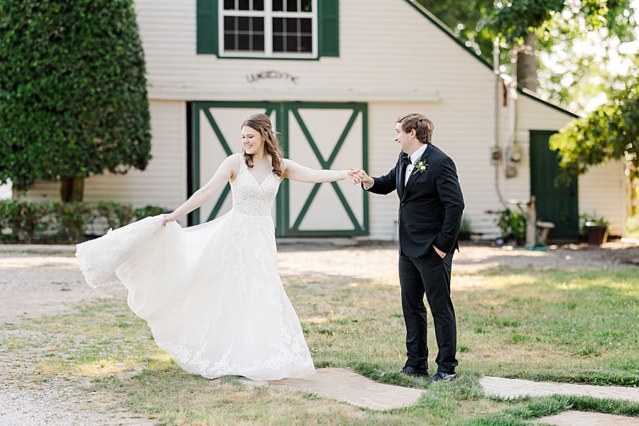 Bride twirling in dress at wedding by Amanda May Photos