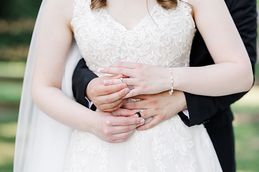 Placing rings on their fingers at wedding by Amanda May Photos