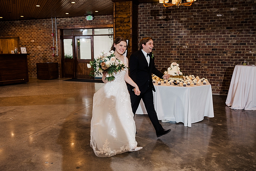 Couple entering reception at wedding by Amanda May Photos