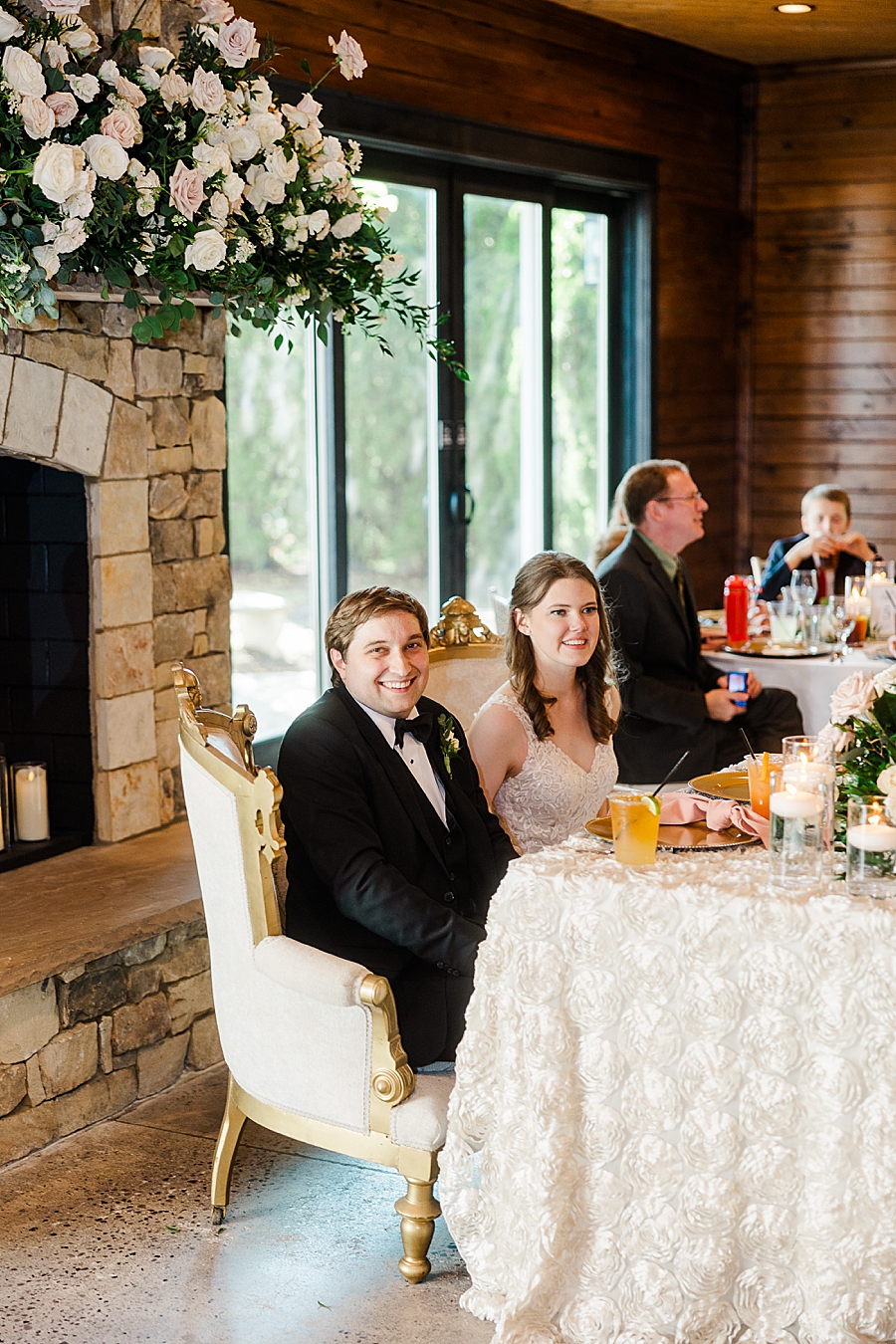 Sitting at the sweetheart table at wedding by Amanda May Photos