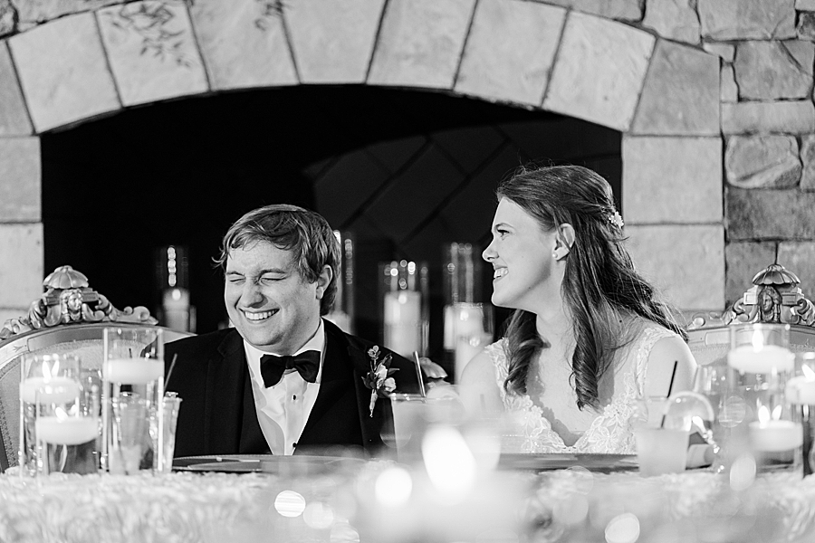 Bride and groom smiling at wedding by Amanda May Photos