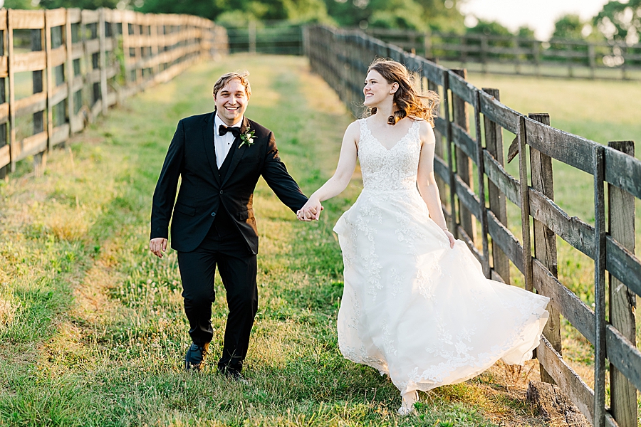 Holding hands and running at wedding by Amanda May Photos