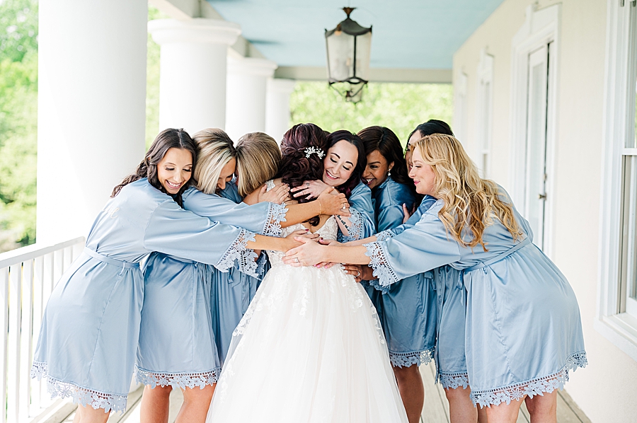 Hugging bridesmaids at Carriage House Wedding by Amanda May Photos