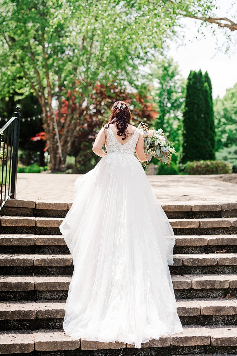 Bride walking up steps at Carriage House Wedding by Amanda May Photos