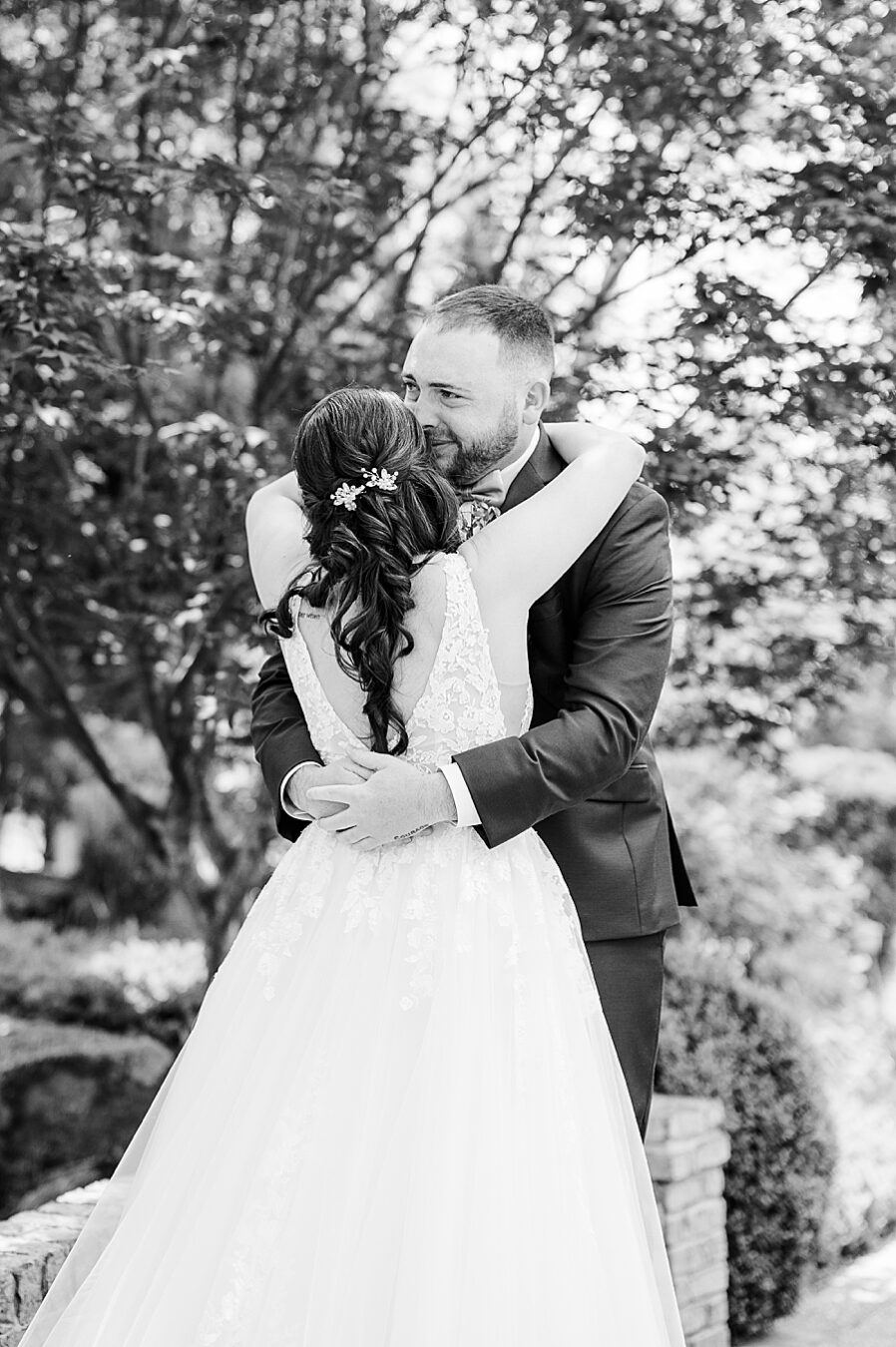 Hugging during first look at Carriage House Wedding by Amanda May Photos