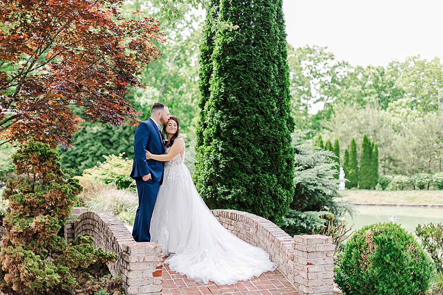 Kissing her forehead at Carriage House Wedding by Amanda May Photos