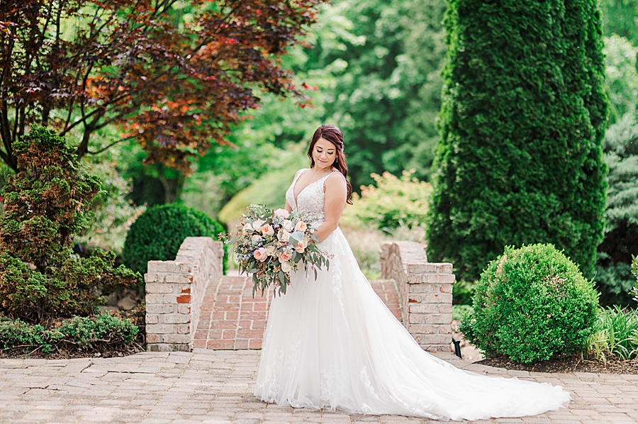 Bride smiling by the bridge at Carriage House Wedding by Amanda May Photos