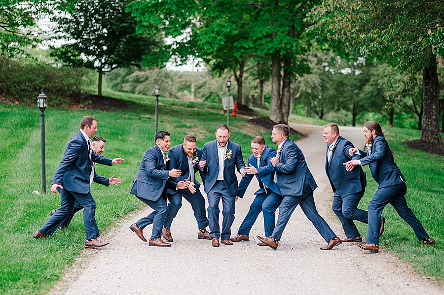 Groomsmen tackle groom at Carriage House Wedding by Amanda May Photos