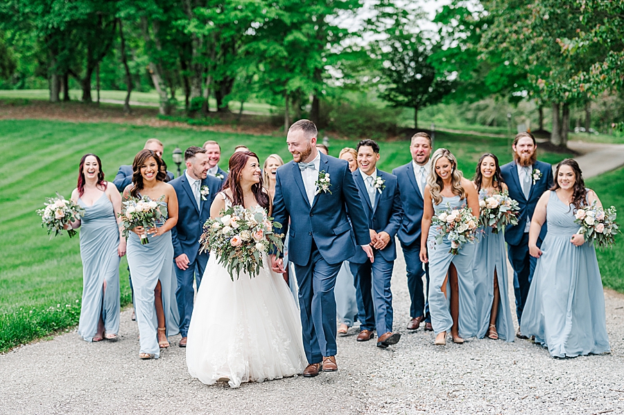 Bride and groom walk with wedding party at Carriage House Wedding by Amanda May Photos