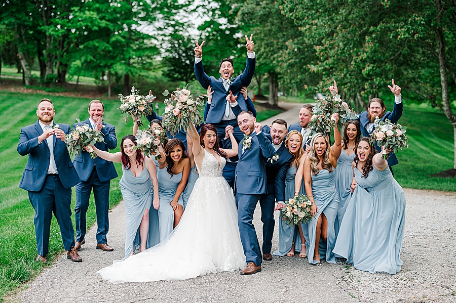 Bride and groom celebrate with wedding party at Carriage House Wedding by Amanda May Photos
