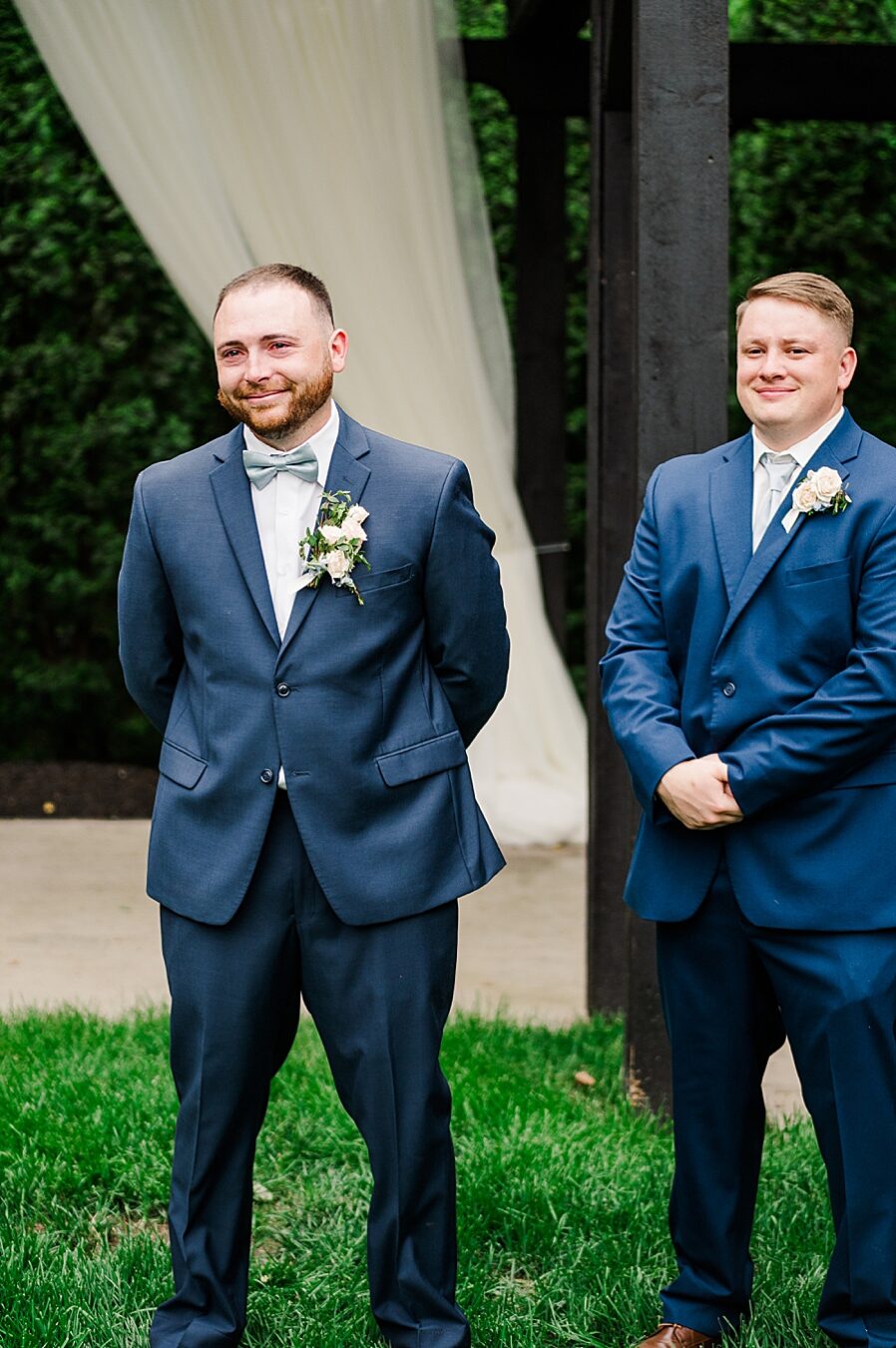 Groom smiling during ceremony at Wedding by Amanda May Photos
