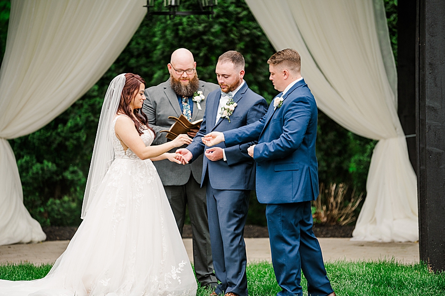 Groomsman give rings at Wedding by Amanda May Photos